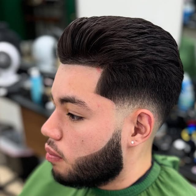 Client's finished pompadour skin fade with a sculpted beard at Elevation Barbershop